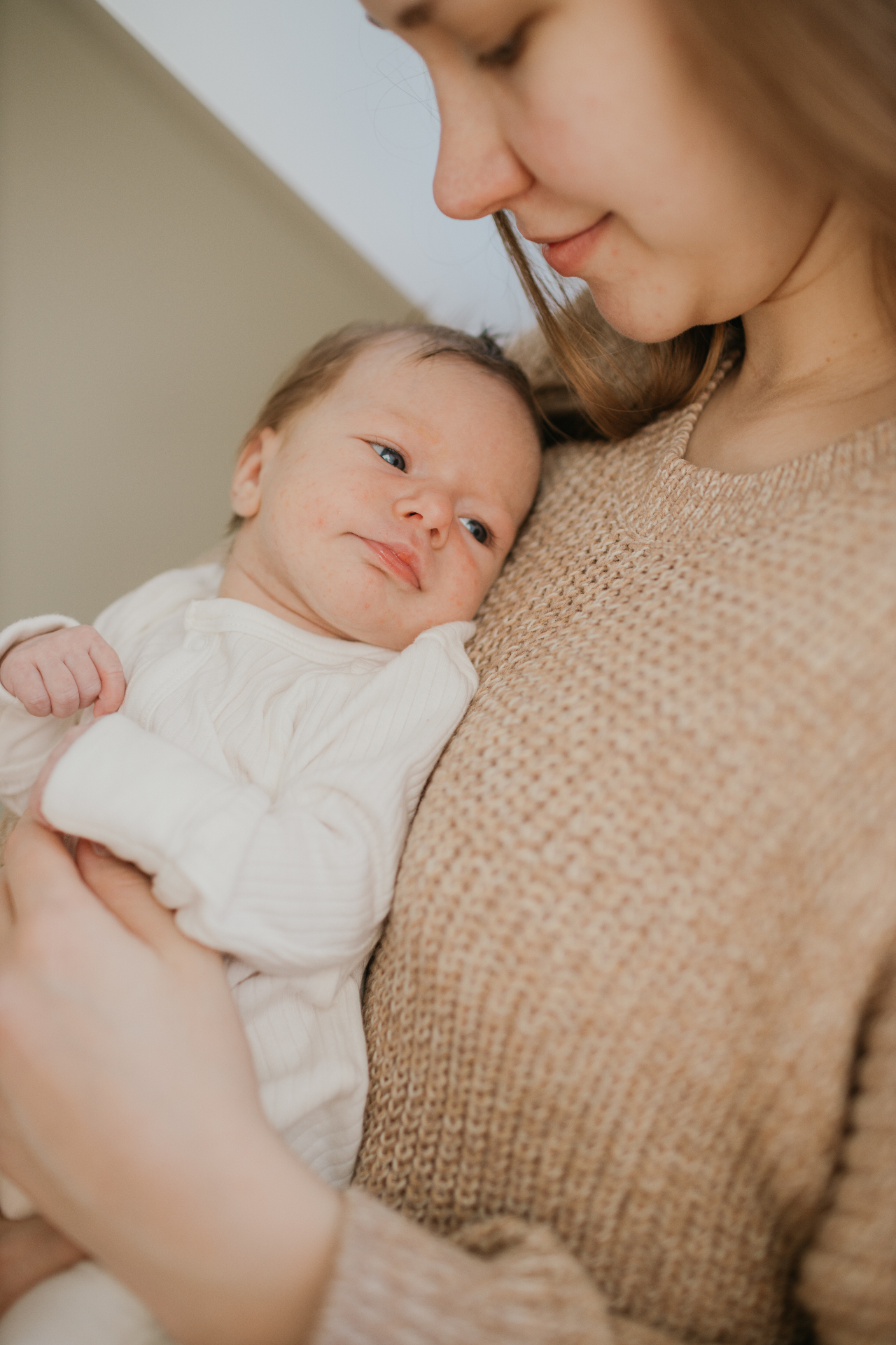 Newborn resting on mother's chest — lifestyle newborn session