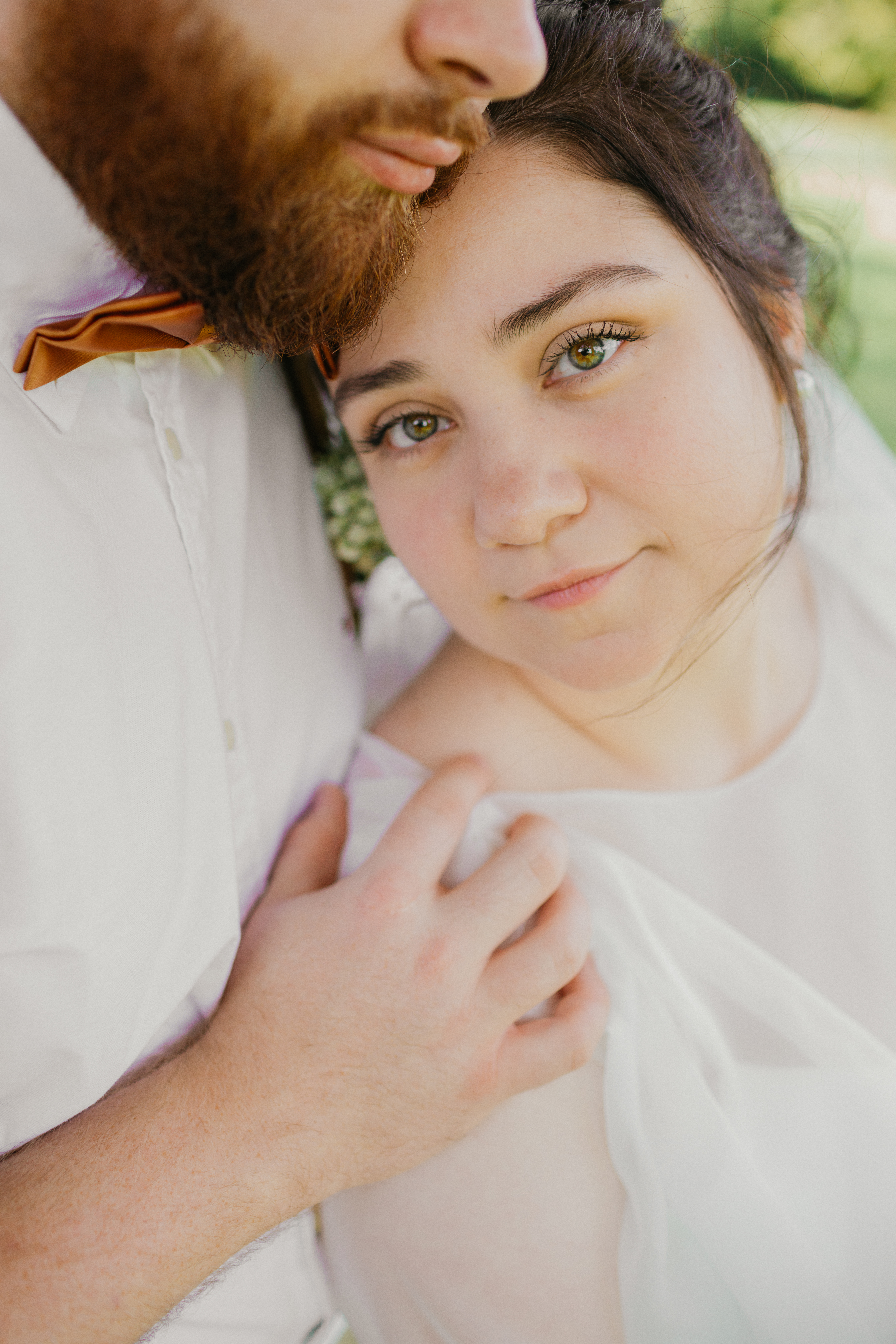 Candid moment between bride and groom in the garden