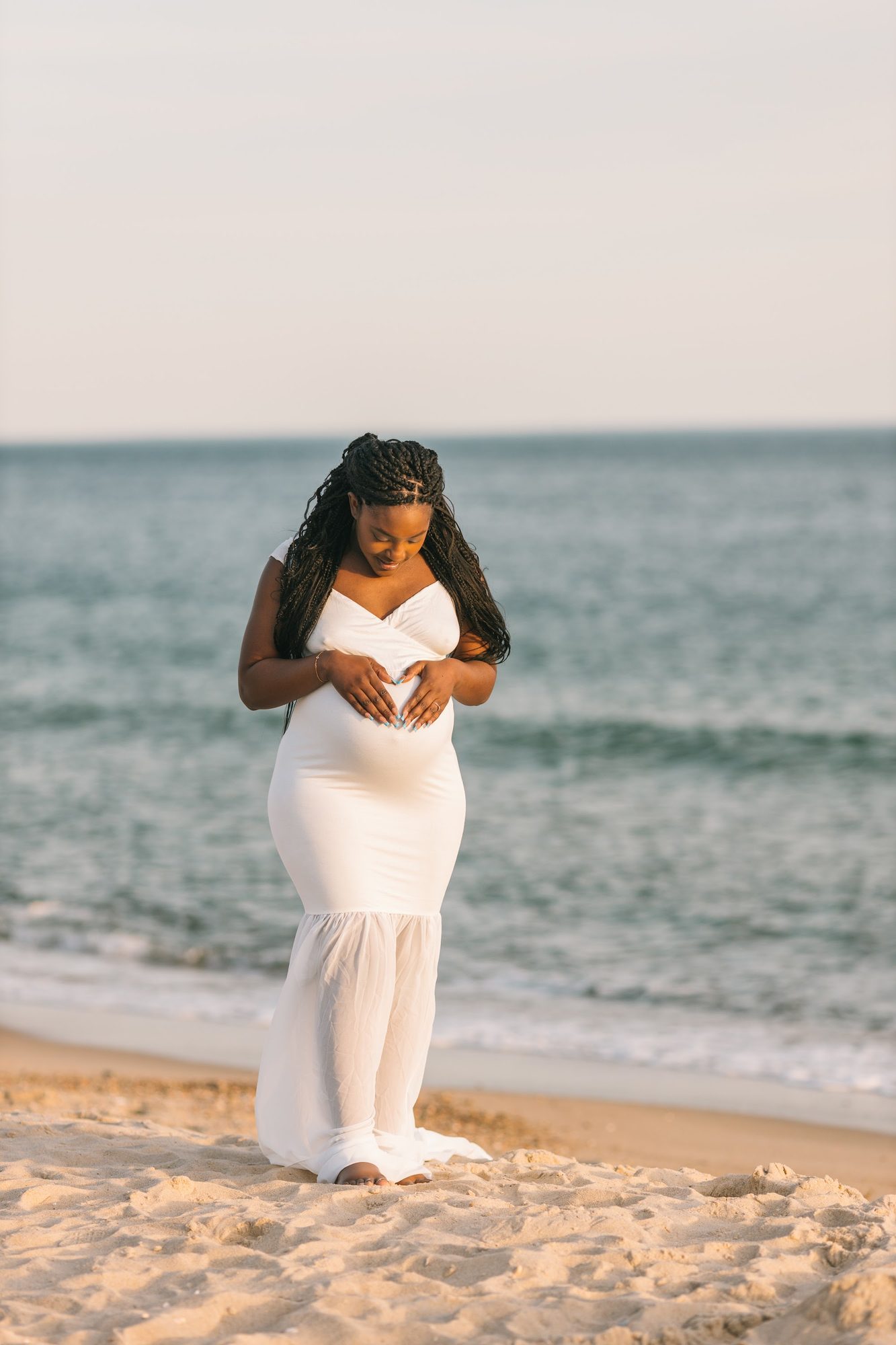 Expecting couple walking the shoreline — coastal maternity session