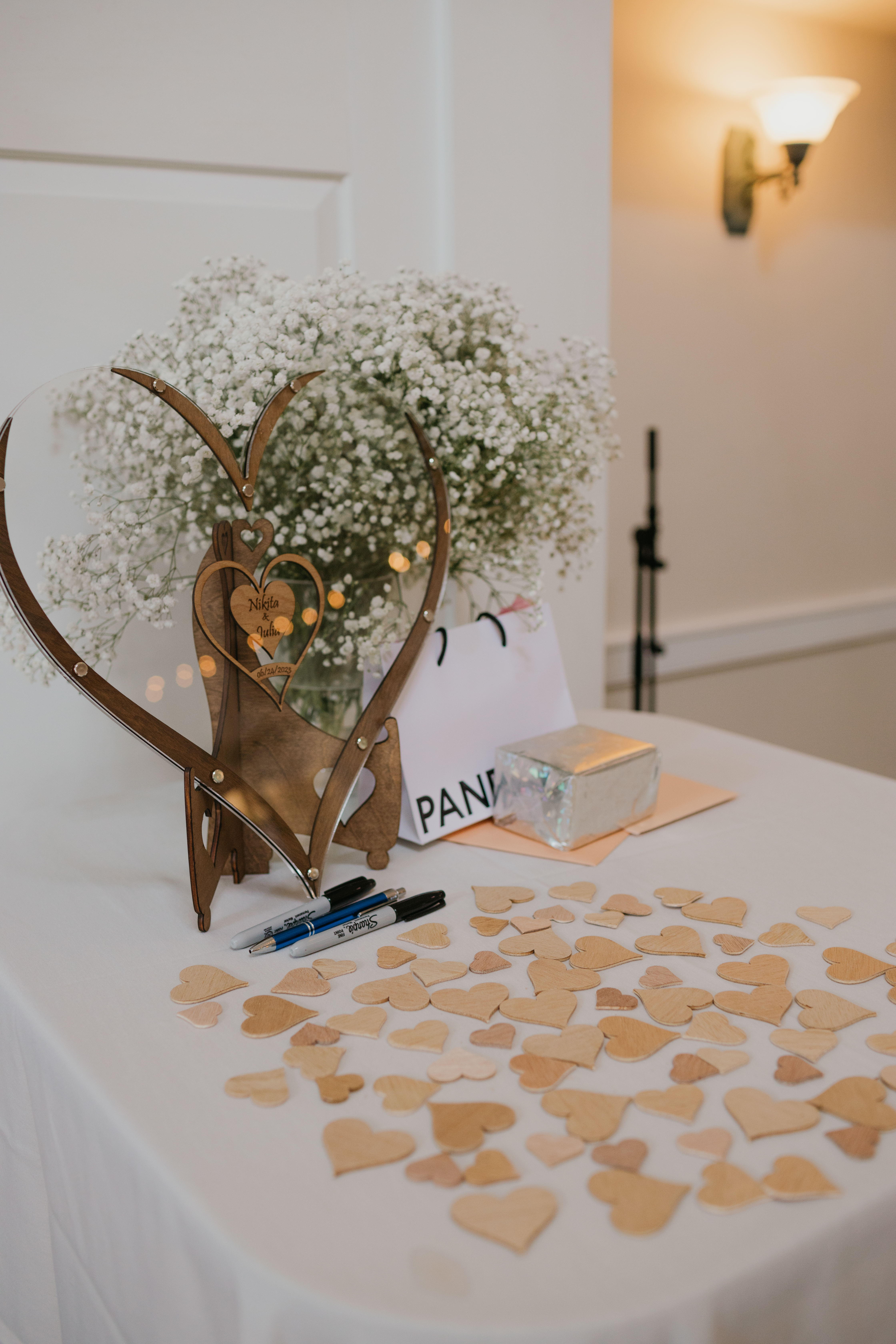 Reception detail — baby's breath heart and guestbook hearts