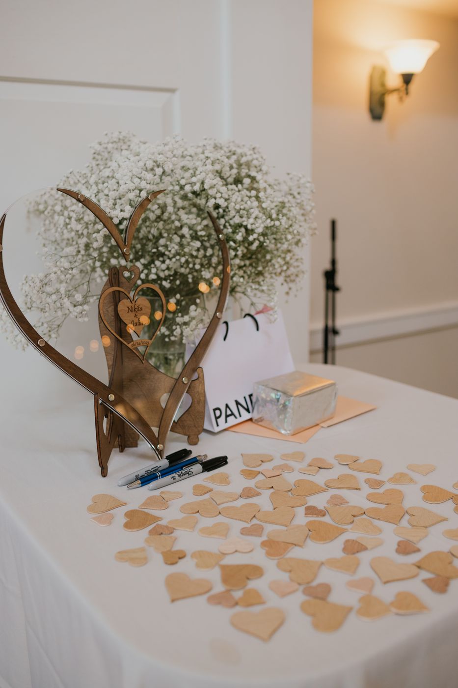 Reception detail — baby's breath heart and guestbook hearts